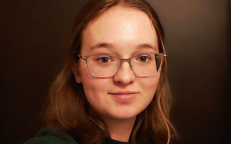 A young blonde girl with glasses
