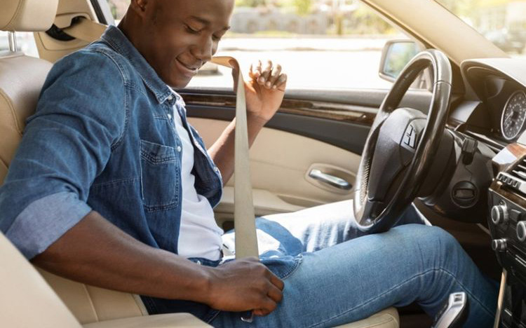 A man buckling his seat belt