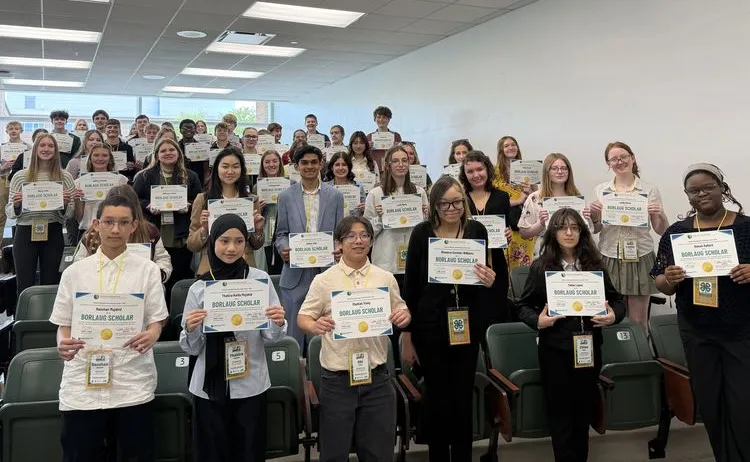 A large group of youths holding up a certificate